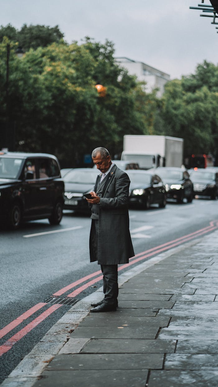 Man in Coat Standing near Street in London